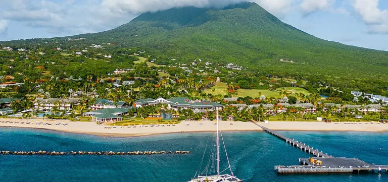 Four Seasons Resort Nevis on Pinney's Beach, with the resort pier in the foreground and Nevis Peak behind
