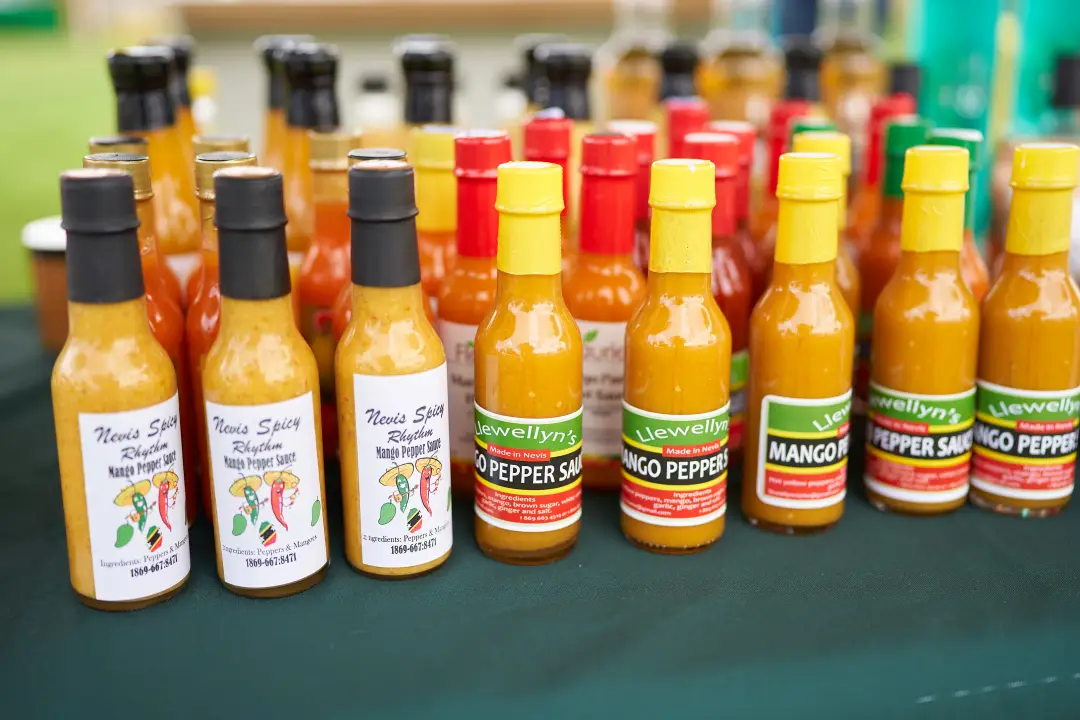 Bottles of locally made Nevis mango pepper sauce on display at the festival
