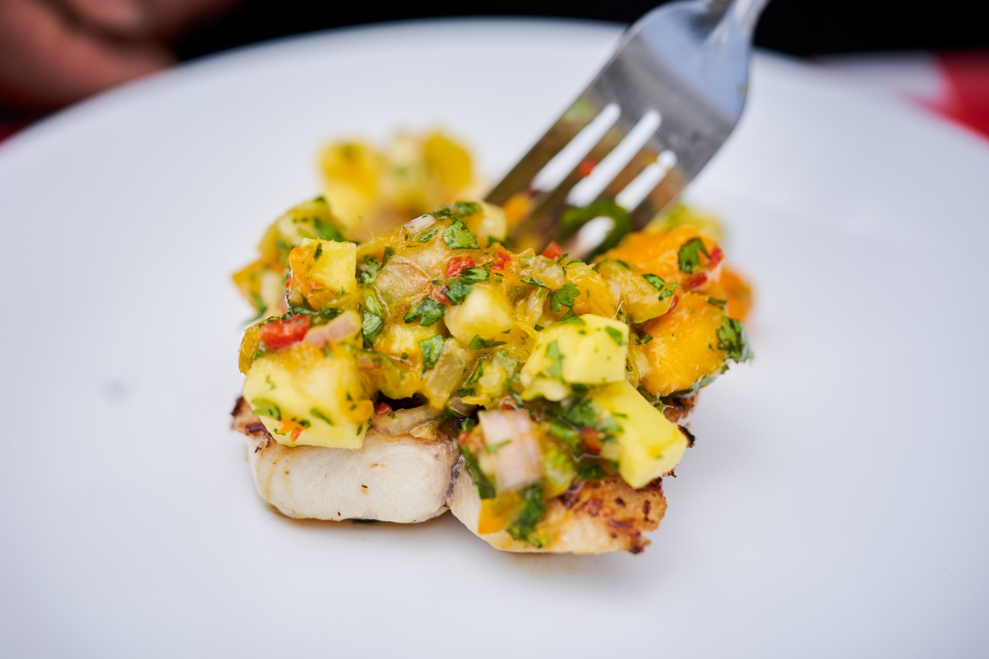 Grilled fish topped with fresh mango salsa served at the Nevis Mango Festival