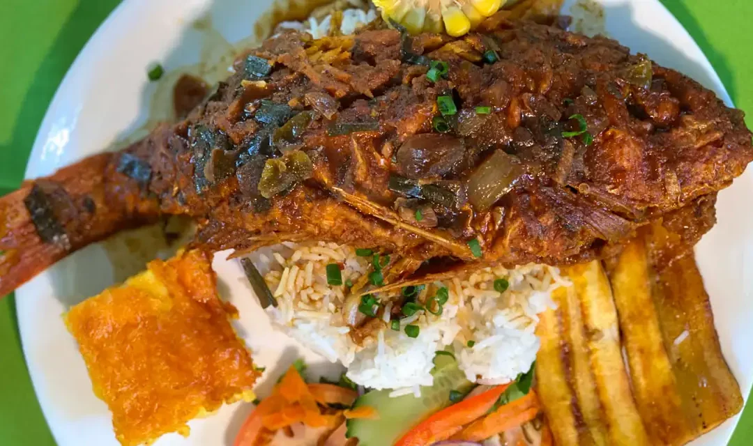 A whole creole snapper served with rice, plantain, pumpkin and salad at Passion Bar and Grill