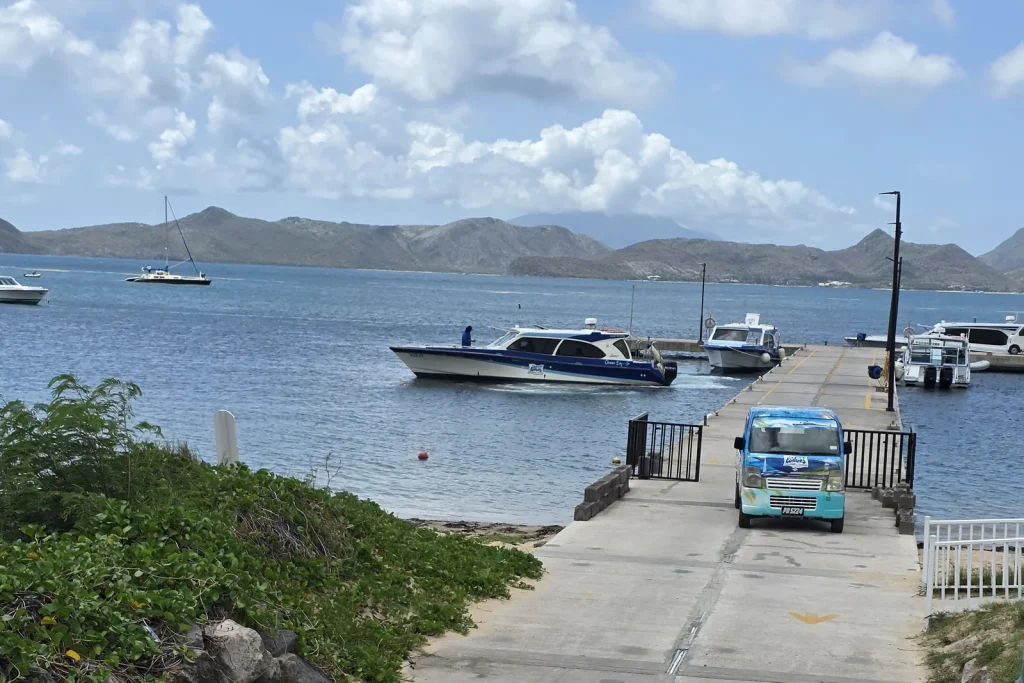 Private water taxi departing Oualie Pier in Nevis, with St. Kitts across The Narrows in the background